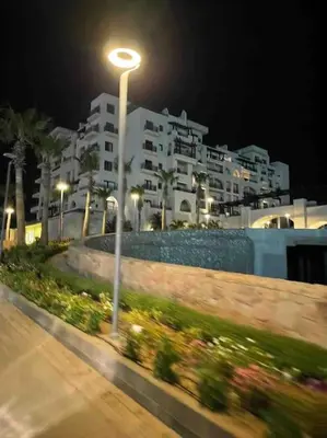 a street light in front of a building at night at Al Dau Heights in Hurghada