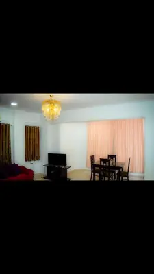 a dining room with a table and chairs and a chandelier at C and S park in Hurghada