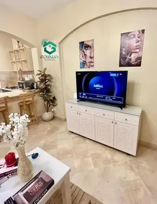 a living room with a flat screen tv on a cabinet at El Gouna west golf Y12 in Hurghada