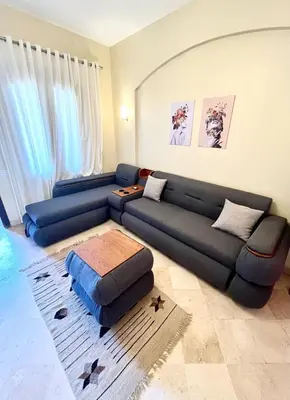 a living room with a blue couch in a room at El Gouna west golf Y12 in Hurghada