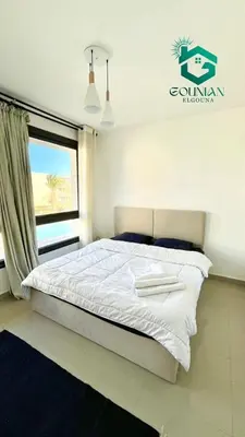 a bedroom with a white bed with a window at ElGouna G-cribs One Bedroom in Hurghada