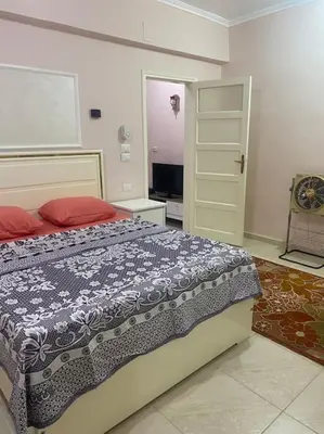 a bedroom with a bed and a television in it at Just the two of us in Luxor