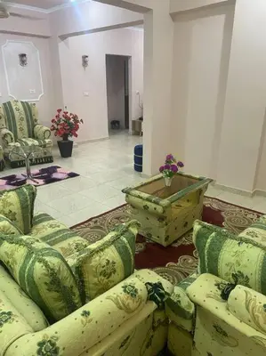 a living room with couches and a coffee table at Just the two of us in Luxor