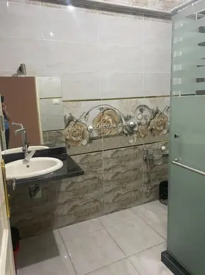 a bathroom with a sink and a glass shower at Just the two of us in Luxor