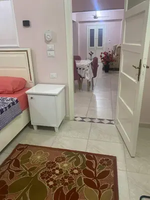 a room with a bedroom with a bed and a door at Just the two of us in Luxor