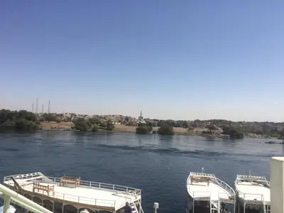 two boats docked at a dock on a river at بيت ملكه house of malaka in Naj‘ al Maḩaţţah