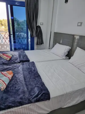 a bedroom with two beds and a window at PANORAMIC BABA DOoL in Aswan