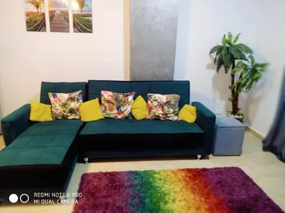 a blue couch with pillows and a colorful rug at Tertels beach resort F 1-7 in Hurghada