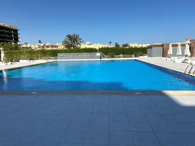 a large swimming pool with blue water at scandic resort 647 in Hurghada