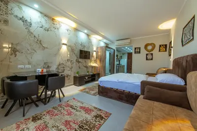 a bedroom with a bed and a desk and a table at scandic resort 523 in Hurghada