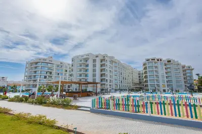 a row of tall apartment buildings with a fence at scandic resort 523 in Hurghada