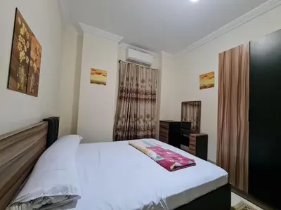 a bedroom with a bed and a dresser in it at Farida in Hurghada