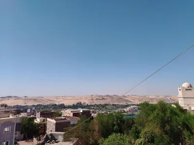 a view of a city with a mosque in the background at Nubian Mood in Naj‘ al Maḩaţţah