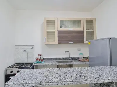 a kitchen with a counter top and a refrigerator at Mabed in Hurghada