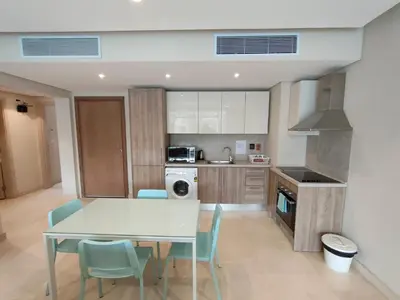 a kitchen with a table and chairs in a room at SunShine Mangrove in Hurghada