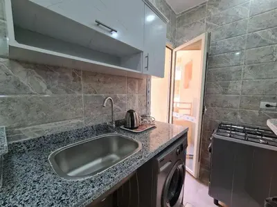 a kitchen with a sink and a stove at Golden Home in Hurghada