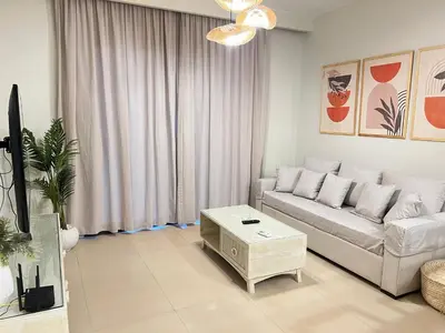a living room with a couch and a table at Stylish 1BR Ground With Free Pool & Lagoon Access In Gouna in Hurghada