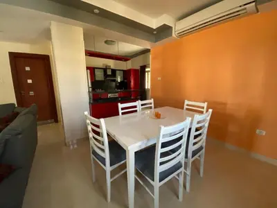 a dining room with a white table and chairs at Hurghada - Magawish Villa 3 in Hurghada