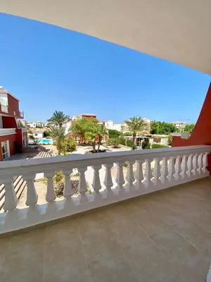 a balcony with white railing and a view of a street at Hurghada - Magawish Villa 3 in Hurghada