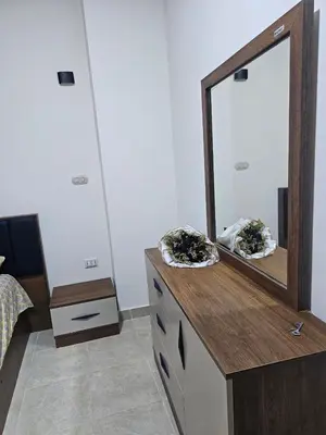 a dresser with a mirror on top of it at Hurghada red ruby in Hurghada