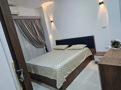 a small bedroom with a bed and a window at Hurghada red ruby in Hurghada