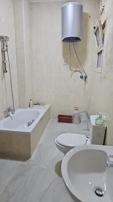 a bathroom with two sinks and a tub and a toilet at Hurghada red ruby in Hurghada
