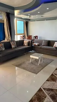 a living room with a couch and a coffee table at The best view of the Nile in Naj‘ al ‘Amrāb