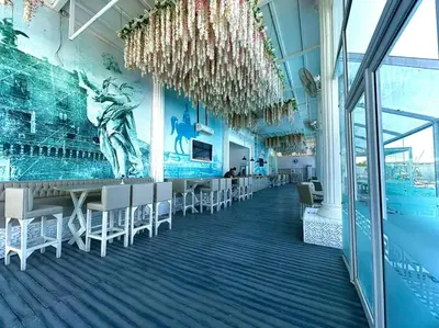 a dining room with chairs and a mural on the wall at Colin beach in Hurghada