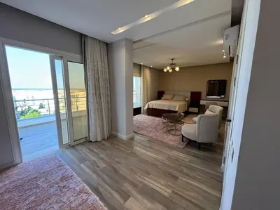 a bedroom with a bed and a living room at Luxury Villa Hurghada Pool Near Senzo Mall 3story in Hurghada