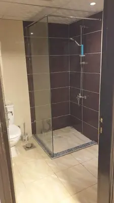 a bathroom with a shower and a toilet at Florenza khamsin Apartment in Hurghada