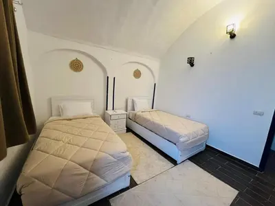 a bedroom with two beds in a room at Sharqotel Luxor in Luxor