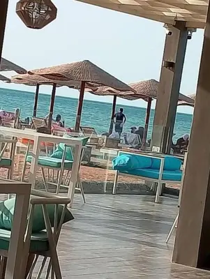 a group of chairs and umbrellas on a beach at Red Sea Hurghada Summer in Winter in Hurghada