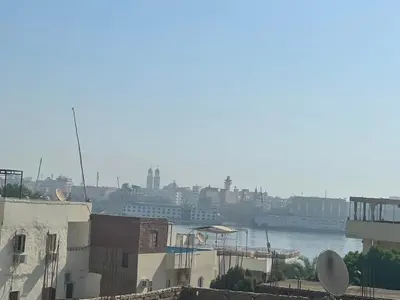 a view of a river with buildings and a city at Nile Temple view in Luxor