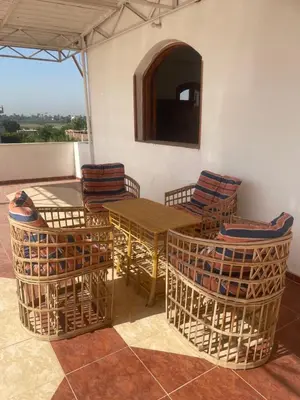 a wooden table and chairs on a patio at Nile Temple view in Luxor