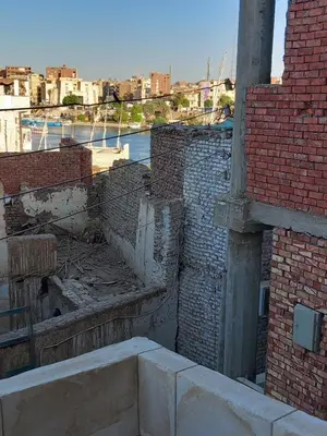 an outside view of a building with a brick wall at Hashem Nubian Guest House in Aswan