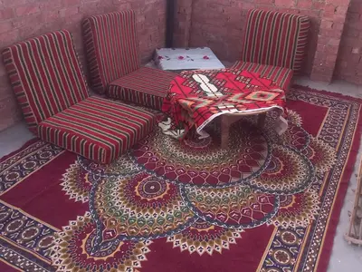 two chairs and a table on a rug at Hashem Nubian Guest House in Aswan