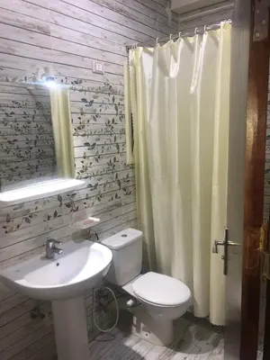 a bathroom with a white toilet and a sink at sea front apartment in Hurghada
