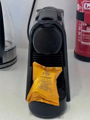 a black coffee maker with a yellow bag in it at Lofty & Lavish 3 BDR Swan Lake El Gouna in Hurghada