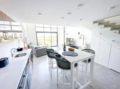 a kitchen with a table and chairs in a room at Beachfront Spacious Somabay Loft in Hurghada