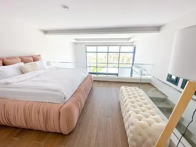 a large bedroom with a large bed and a large window at Beachfront Spacious Somabay Loft in Hurghada
