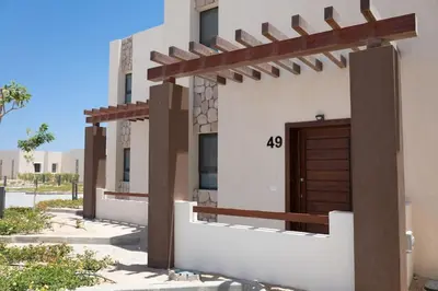 a building with a wooden door on the side of it at Beachfront Spacious Somabay Loft in Hurghada