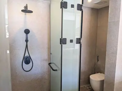 a shower stall in a bathroom with a toilet at Magical Cabana Steps From Beach & Pool in Hurghada