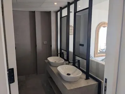 a bathroom with two sinks and a large mirror at Magical Cabana Steps From Beach & Pool in Hurghada