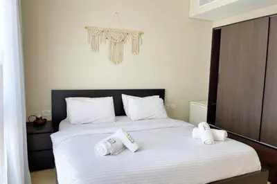 a bedroom with a bed with towels on it at Minimal & Mere 1 BDR Mangroovy Free Beach & Pool in Hurghada