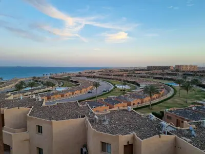an aerial view of a city and the ocean at Minimal & Mere 1 BDR Mangroovy Free Beach & Pool in Hurghada