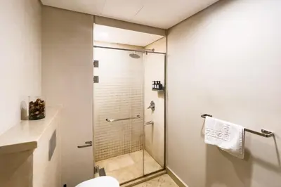 a bathroom with a shower and a toilet at Scenic Pool Front 1 BDR Mangroovy Free Pool & Beach in Hurghada