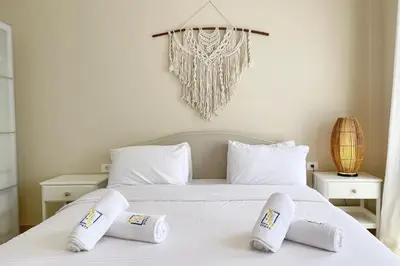 a bedroom with a white bed with two pillows at Embellished 2BDR Penthouse Mangroovy Free Pool & Beach in Hurghada