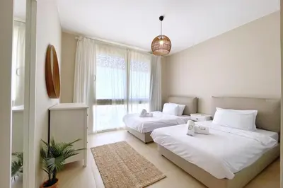 a bedroom with two beds and a window at Embellished 2BDR Penthouse Mangroovy Free Pool & Beach in Hurghada