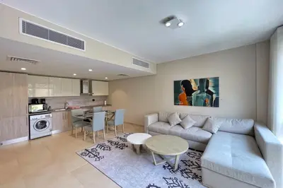 a living room with a couch and a table at Peaceful & Placid 1 BDR Mangroovy Free Pool & Beach in Hurghada