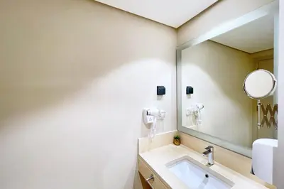 a bathroom with a sink and a mirror at Peaceful & Placid 1 BDR Mangroovy Free Pool & Beach in Hurghada